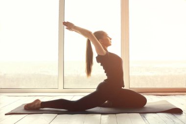 Yoga ve jimnastik yapan genç ve güzel bir kadın. Sağlık konsepti. Tek sporlu dersler.