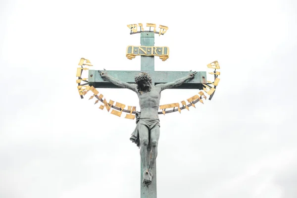 Statue of the crucifixion of Christ on the Charles bridge in Prague, Czech Republic Royalty Free Stock Photos