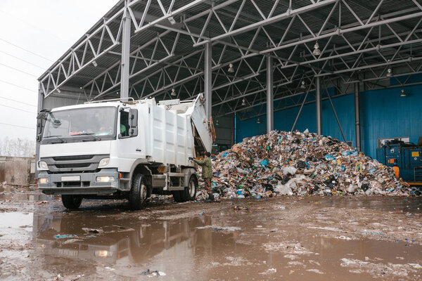 A special truck unloads waste. Transportation of waste. Technological process. Recycling and storage of waste for further disposal. Business for sorting and processing of waste.