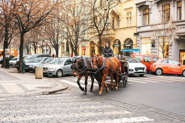 Prague, Czech Republic, December 24, 2016: Horseback riding in a coach in Prague. Entertainment of tourists in Christmas Europe. Christmas in Europe.