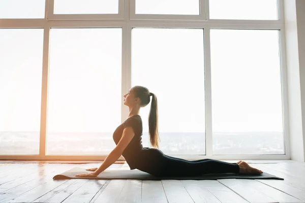 Jonge mooie vrouw die yoga en gymnastiek beoefent. Wellnessconcept. Klassen in één sport. — Stockfoto