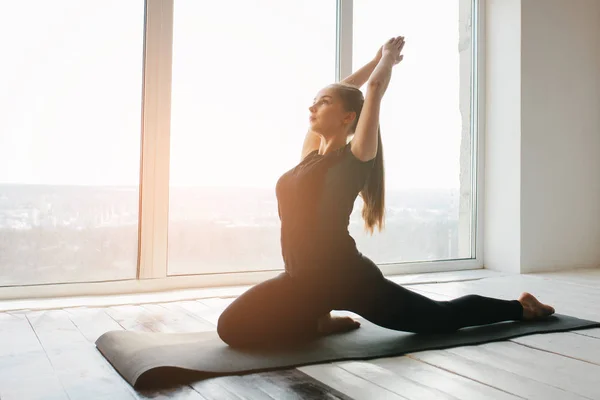 Fiatal, gyönyörű nő, aki jógázik és tornázik. Wellness koncepció. Egyedülálló sportórák. — Stock Fotó