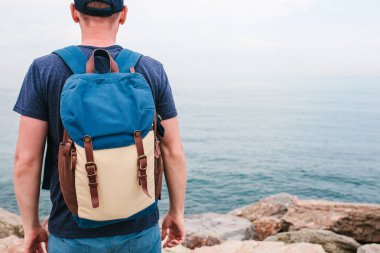 Deniz kenarı bir sırt çantası ile bir turist. Seyahat, turizm, rekreasyon.