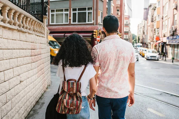 Young couple walking along the street in Istanbul. Urban life style. Routine, downtown. Life in Turkey.