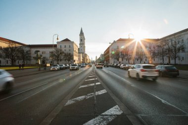 Yolun bir bakış, Münih - Almanya Bavyera'da başkenti sokak Leopoldstrasse üzerinde. Hızlı hareket araba günbatımı arka plan üzerinde bulanık.