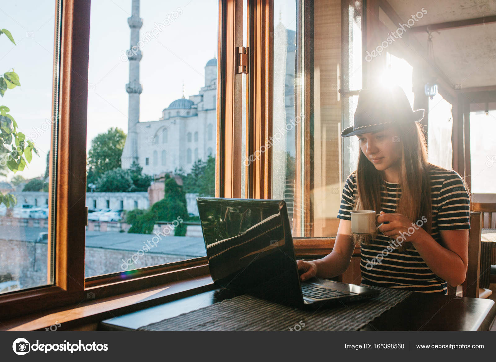 A Young Female Tourist Blogger Freelancer Working On A Laptop In A