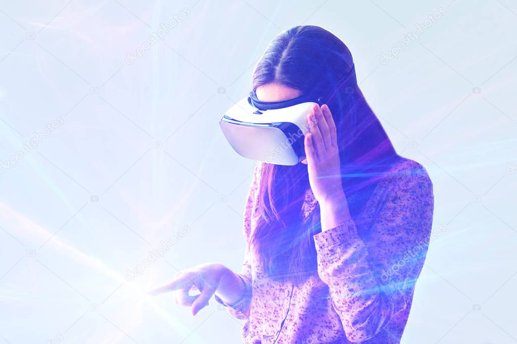 Young woman with virtual reality glasses. Modern technologies. The concept of future technology.