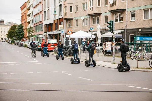 Berlin, October 3, 2017: Group of tourists riding on gyroscooters along the streets of Berlin during excursion — Stock Photo, Image