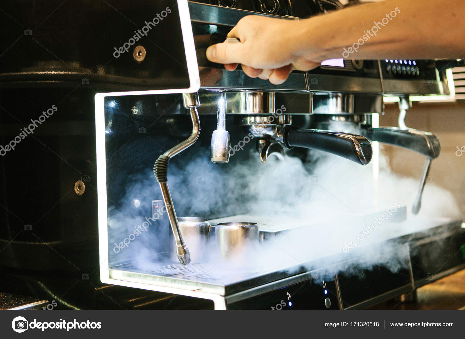 A man is repairing a broken coffee machine in a cafe. There is steam, wrong  work. Support and repair. Stock Photo by ©fransz 171320518