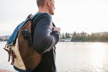 Avrupa'nın Çek Cumhuriyeti Prag evlerin zemin üzerine Nehri yanındaki bir sırt çantası ile turist adam sahanın. Seyahat, gezi, turizm.