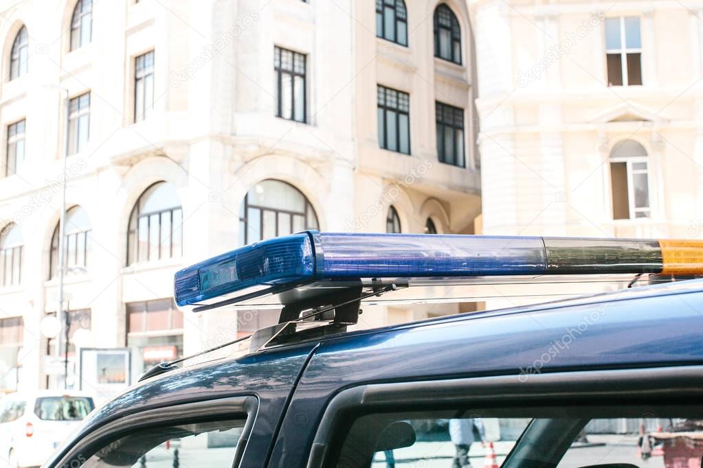 Part of the police car is a siren on the background of the buildings. Conceptual photo of public order protection, representatives of power, protection of the population from crime. Authorities.
