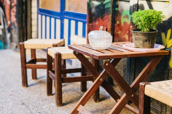 Turkish street cafe in Istanbul. Wooden table and chairs stand directly on the street. A distinctive and authentic place to visit by locals. Small business. — Stock Photo, Image