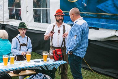 Prag, 23 Eylül 2017: Çek Cumhuriyeti'nde geleneksel Alman Bira Festivali Oktoberfest kutluyor. Baba oğul yakın duruyor arkadaşı ile iletişim kurar. Bira çok yakın.