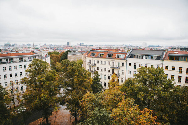 View from high point to the street with buildings with trees in Berlin in Germany.