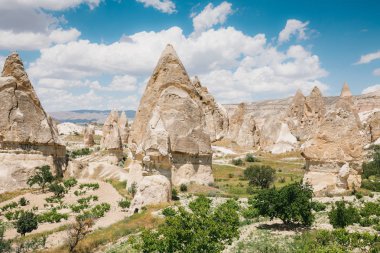 Hills Kapadokya'nın güzel manzarasına. Bir Türkiye manzaraları. Mavi bir gökyüzü bulutlu içinde belgili tanımlık geçmiş.