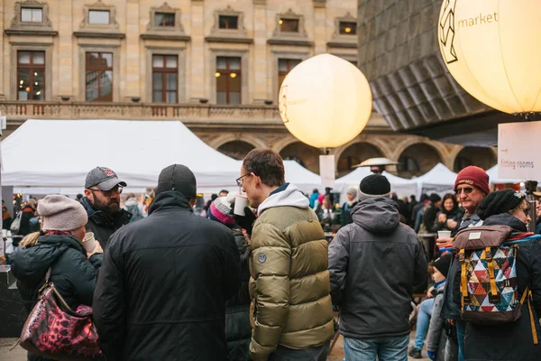 Prague, December 18, 2017: People shoppers walk around the annual popular Christmas designer street market called the Designer Market and are looking for handmade gifts. — Stock Photo, Image