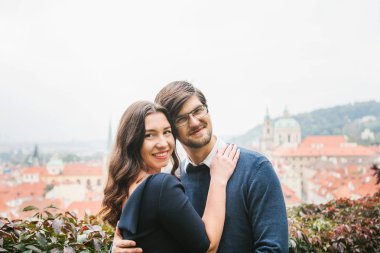 Sevgi dolu genç güzel bir çift Avrupa'dan öğrenci Prag güzel bir manzara fonunda kucaklamak. Hisler ve duygular insanlar arasında kapatın. Çerçevede gülümse