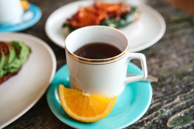 Turuncu bir dilim ile aromatik yararlı lezzetli çay bir fincan. Yararlı ve lezzetli bir kahvaltı.