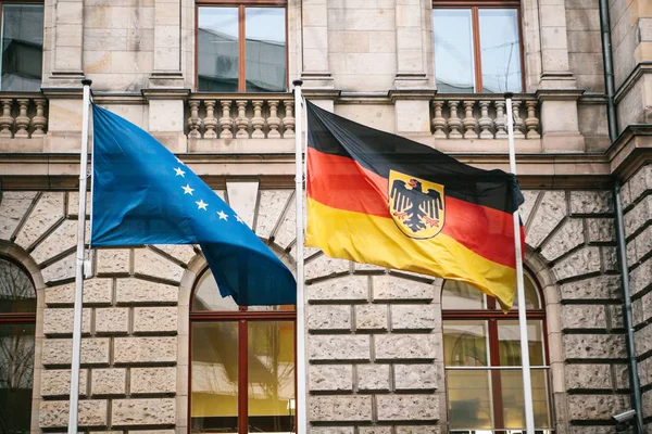 Flag of Germany and the European Union in Berlin. State symbol and national government flag of the Federal Republic of Germany and EU