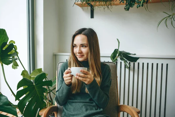Girl drinks a hot drink