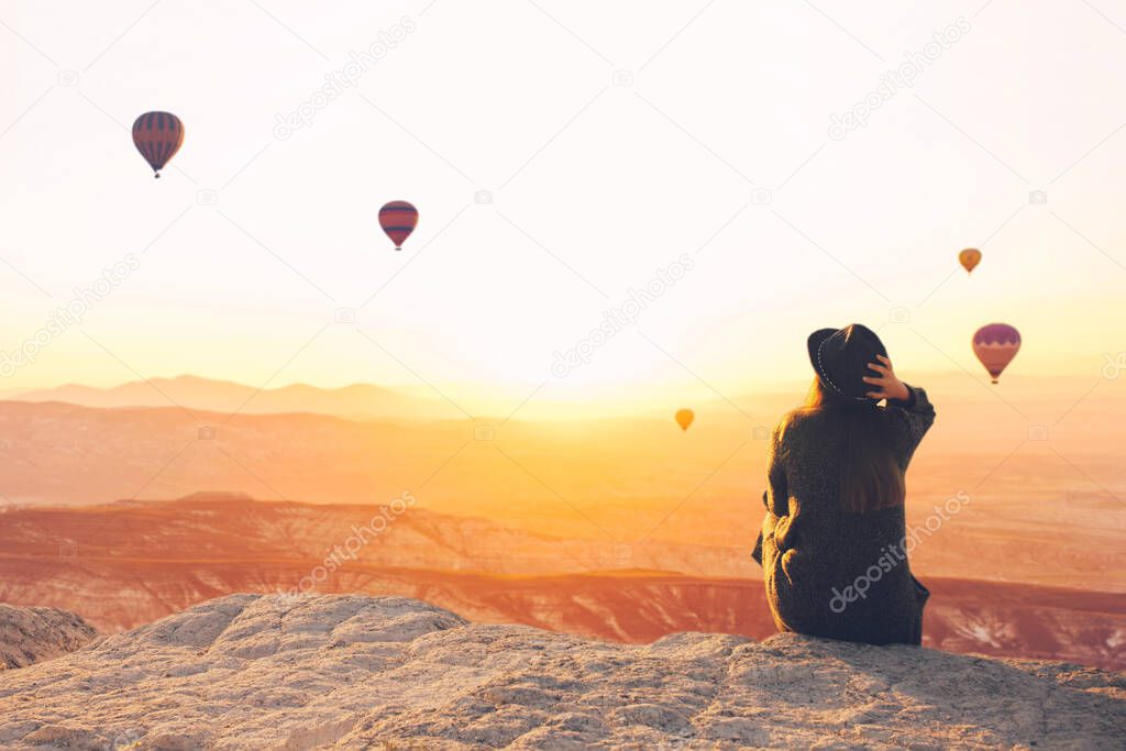 A girl admires hot air balloons