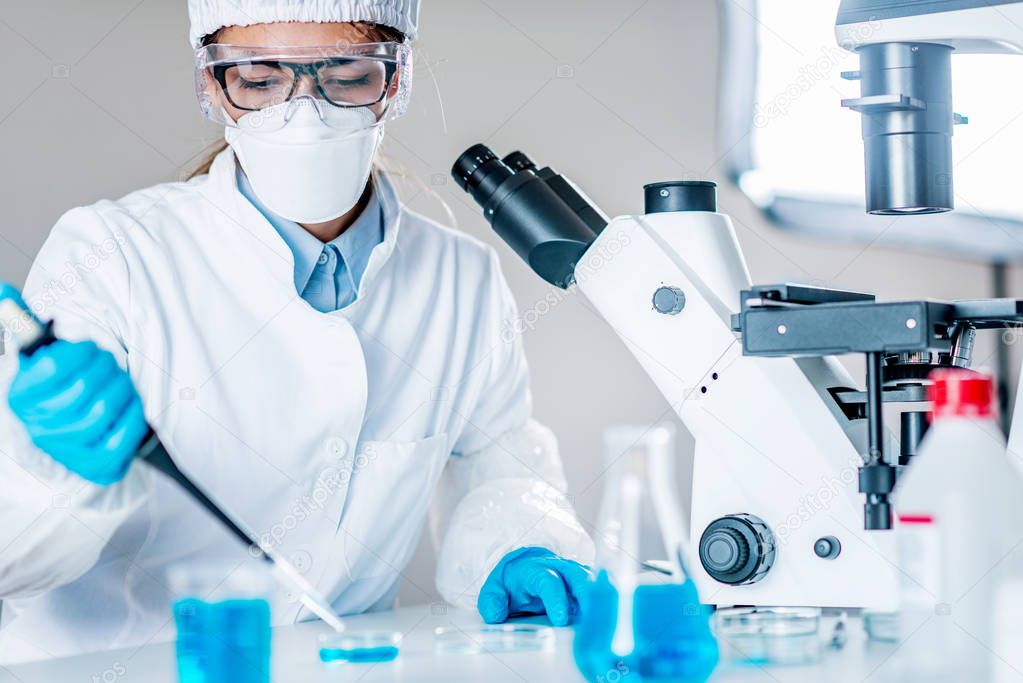 Life science research. Technician using micro pipette