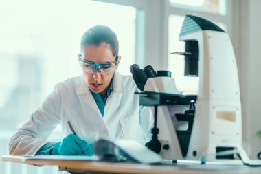 female Scientist working in laboratory clipart