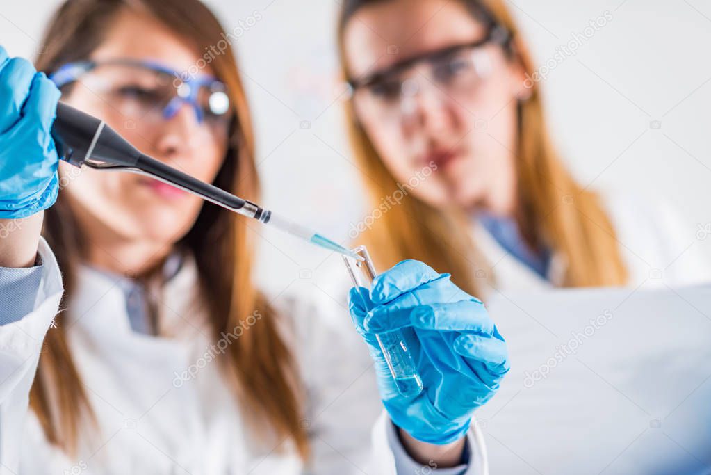 Female researchers using micro pipette