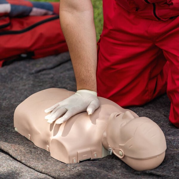 Cpr training outdoors. Reanimation procedure on CPR doll