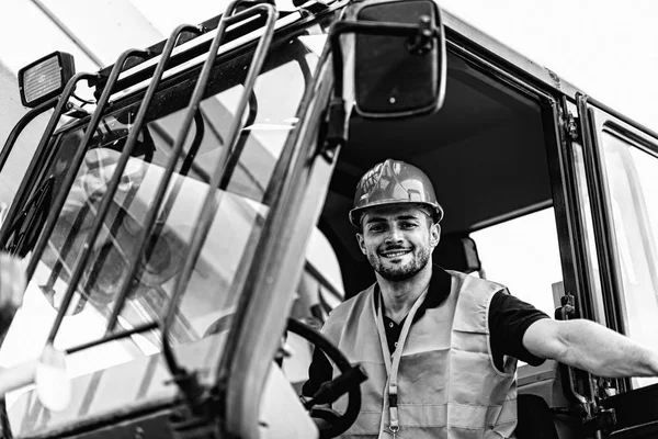 Construction worker operating on Skid Steer Loader