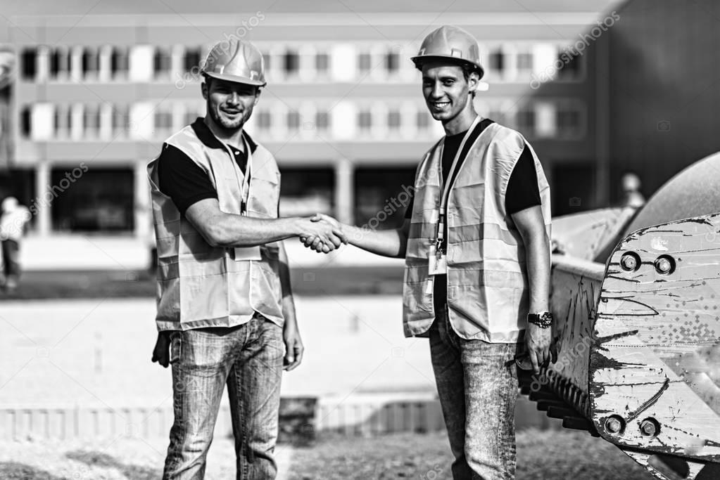 Portrait of engineers handshaking at construction site