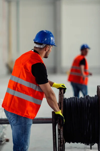 Manual Workers Spining Out Cable — Stock Photo, Image