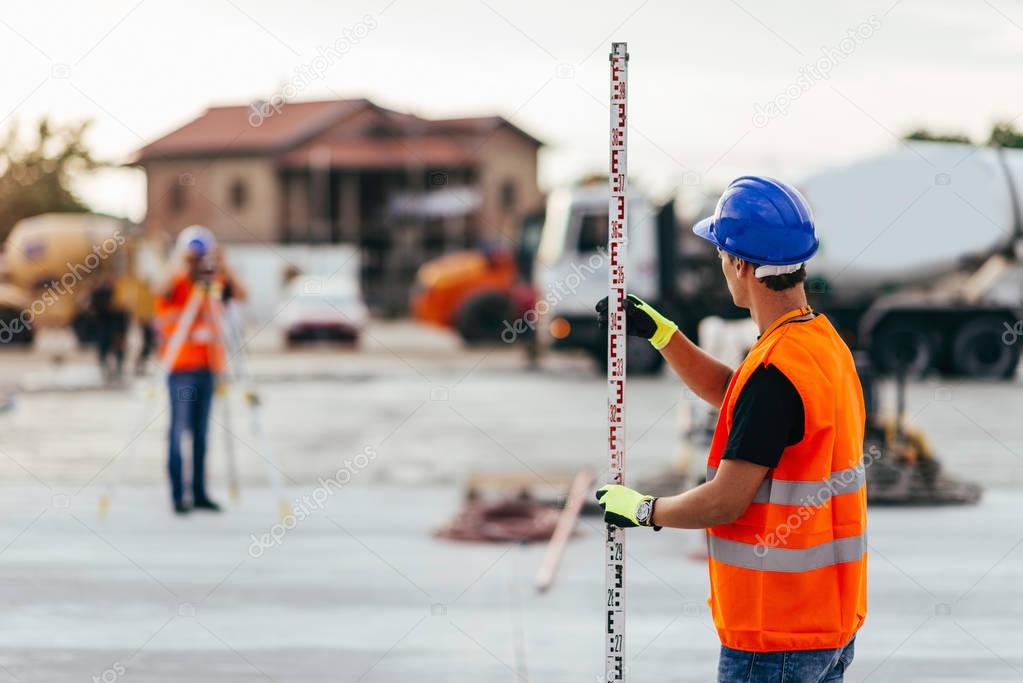 Surveyors working on construction site