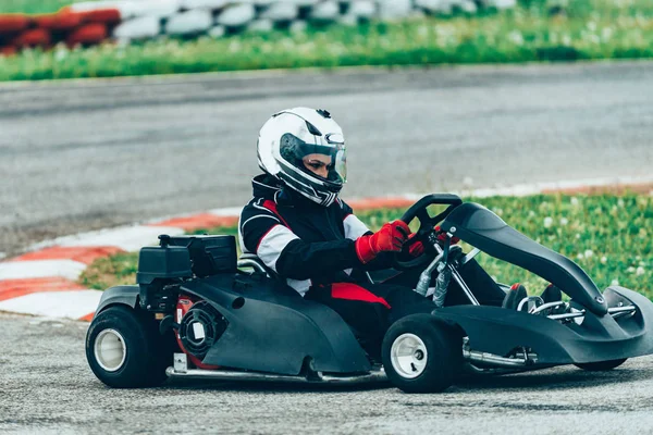 Woman driving go-cart on a sports track