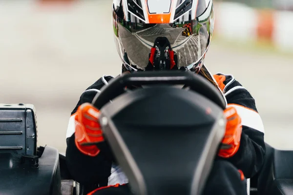 Woman driving go-cart on a sports track