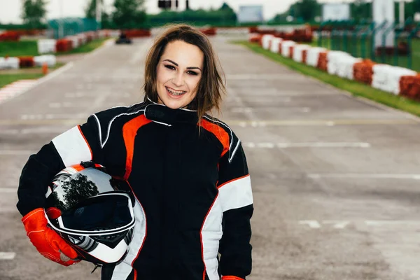 Woman holding safety helmet at on a sports track
