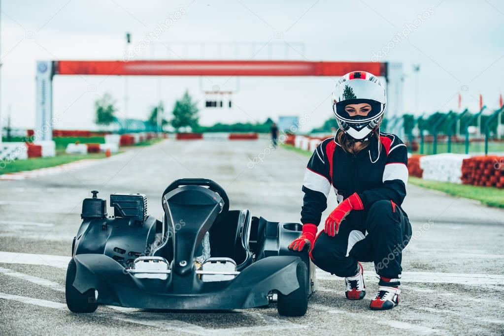 Woman sitting at  go-cart on a sports track