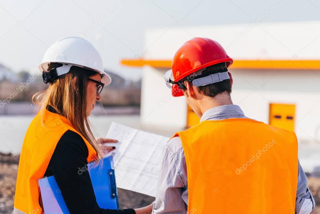 Rear view of Engineers on construction site