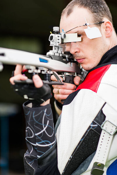 Мужчина, практикующий стрельбу на соревнованиях с бесплатной винтовкой
