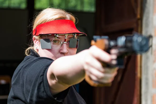 Woman concentrating on sport shooting training