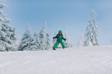Küçük çocuk güneşli günde dağda Kayak