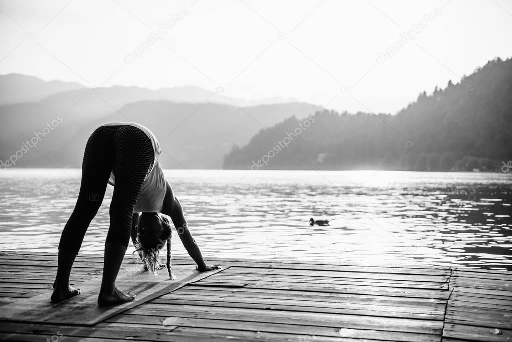 Female in Sun Salutation Pose by the lake