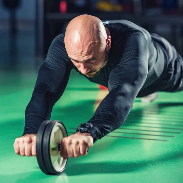 Man Exercising Abs Roller Gym — Stock Photo, Image