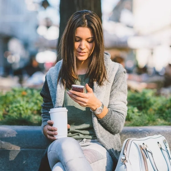 Adolescente Con Café Para Llevar Ciudad Sentado Usando Teléfono Móvil — Foto de Stock