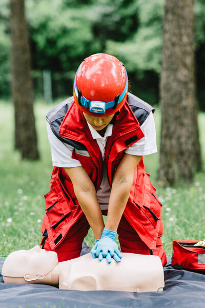 Cpr training of woman on cpr  dummy outdoors