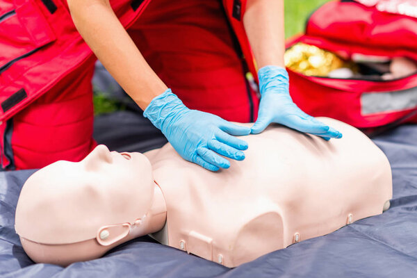Cpr training of woman on cpr  dummy outdoors