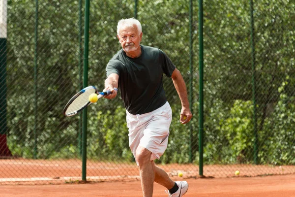 Senior man exercising tennis