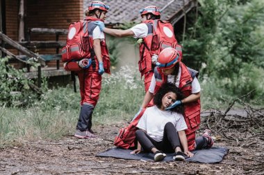 Paramedics rescuing disaster victim clipart