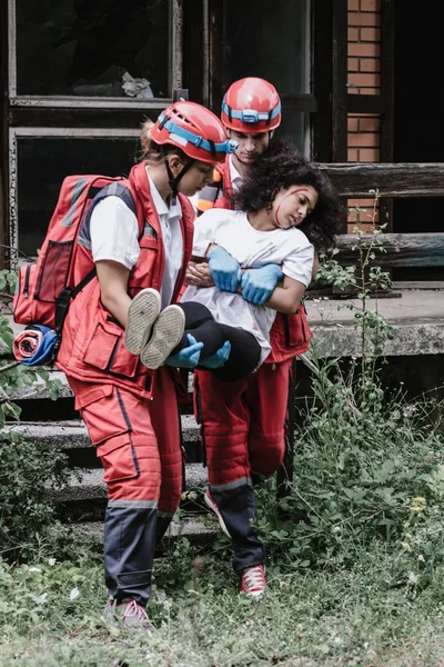 Stock image Rescuers evacuating victim from the house 