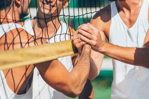 Beach volleyball players after match congratulating each other